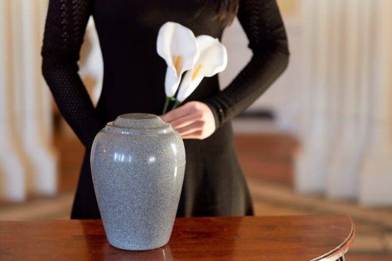 woman with cremation urn at funeral in church